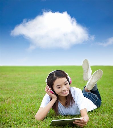 students tablets outside - happy girl using touch pad computer with headphone on  the meadow Stock Photo - Budget Royalty-Free & Subscription, Code: 400-05901157