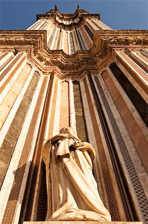 A view looking upwards to the top of one of the twin belltowers of the main cathedral, the Duomo, in Orvieto. The extreme perspective foreshortens the tower. Stock Photo - Budget Royalty-Free & Subscription, Code: 400-05901723