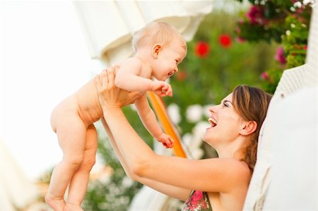 simsearch:400-06086432,k - Happy young mother laying on sunbed and playing with baby Stockbilder - Microstock & Abonnement, Bildnummer: 400-05902144