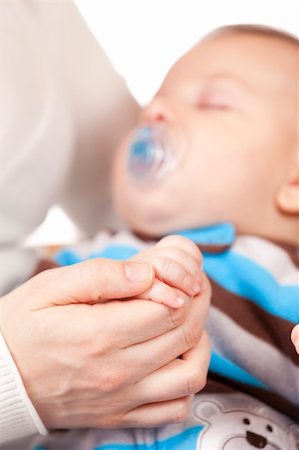 pacifier mom holding - Portrait of a mother and baby holding hands Stock Photo - Budget Royalty-Free & Subscription, Code: 400-05902341