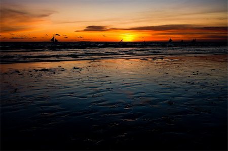 view over a tropical beach against a beautiful sunset Stock Photo - Budget Royalty-Free & Subscription, Code: 400-05902745