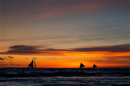 tropical beach with sailing boats at sunset Stock Photo - Budget Royalty-Free & Subscription, Code: 400-05902746