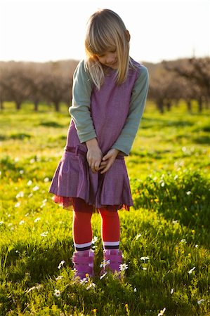 simsearch:400-06768635,k - Cute little girl outdoors on a green field with flowers Foto de stock - Royalty-Free Super Valor e Assinatura, Número: 400-05903021