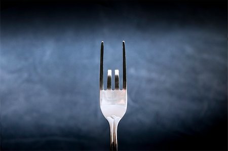 simsearch:400-04680939,k - The fork with two bent pins with blue background Fotografie stock - Microstock e Abbonamento, Codice: 400-05914333