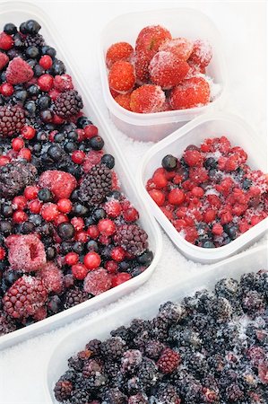 Plastic containers of frozen mixed berries in snow - red currant, cranberry, raspberry, blackberry, bilberry, blueberry, black currant, strawberry Stock Photo - Budget Royalty-Free & Subscription, Code: 400-05915124