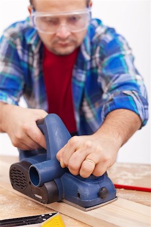 Man working with wooden planck and electric planer - closeup Stock Photo - Budget Royalty-Free & Subscription, Code: 400-05915216
