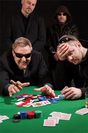 Photo of two male poker players, one winning and the other losing, while security watches over their shoulders. Cards have been altered to be generic. Stock Photo - Budget Royalty-Free & Subscription, Code: 400-05916297