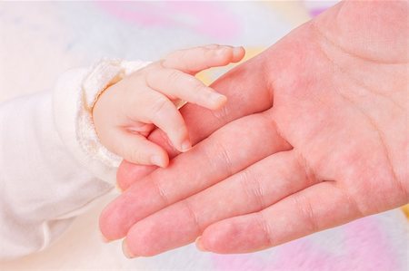 Close-up of baby's hand holding mother's hand Stock Photo - Budget Royalty-Free & Subscription, Code: 400-05917284