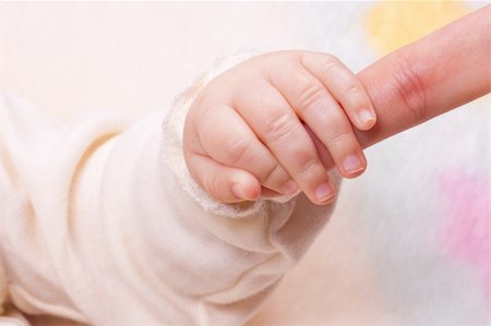 Close-up of baby's hand holding mother's hand Stock Photo - Budget Royalty-Free & Subscription, Code: 400-05917283