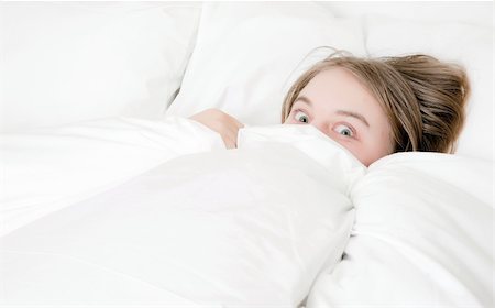 young woman looking from under the covers Stock Photo - Budget Royalty-Free & Subscription, Code: 400-05917853