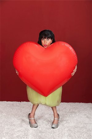 Retro-styled woman with big heart shaped balloon Stock Photo - Budget Royalty-Free & Subscription, Code: 400-05918404