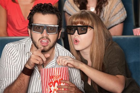 simsearch:400-06138368,k - Caucasian couple with 3D glasses and popcorn watch a movie Fotografie stock - Microstock e Abbonamento, Codice: 400-05918422