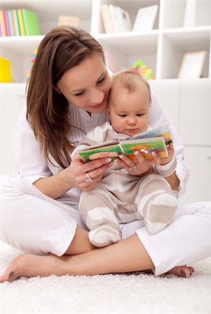 Look what a cute little ... woman and little girl watching a baby booklet Stock Photo - Budget Royalty-Free & Subscription, Code: 400-05919458