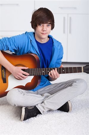 simsearch:400-04152181,k - Young teenager boy playing the acoustic guitar Stock Photo - Budget Royalty-Free & Subscription, Code: 400-05919475