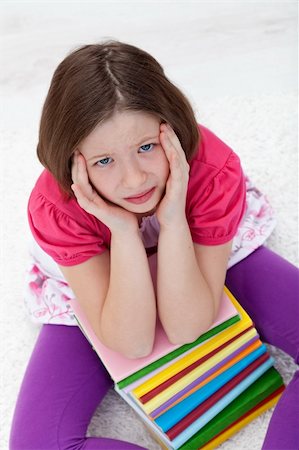 school girl holding pile of books - Young school girl with headache from fatigue Stock Photo - Budget Royalty-Free & Subscription, Code: 400-05919495