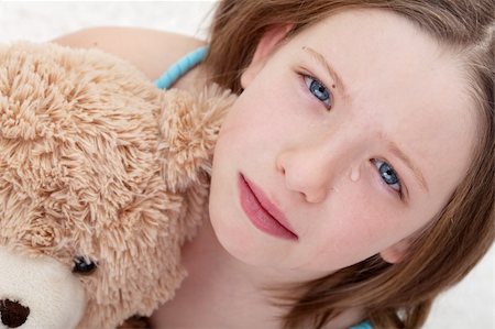 Beautiful sad girl holding teddy bear and crying - closeup Stock Photo - Budget Royalty-Free & Subscription, Code: 400-05919502