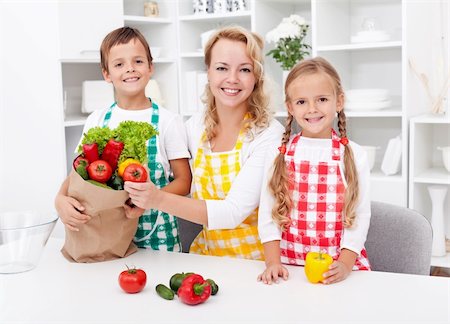 shopping bags in kitchen - Woman and kids unpacking the groceries in the kitchen Stock Photo - Budget Royalty-Free & Subscription, Code: 400-05919521