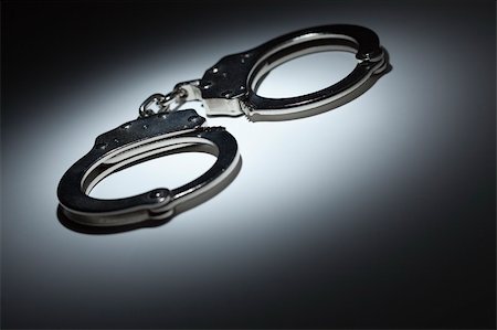 pictures of hands in handcuffs - Abstract Pair of Handcuffs Under Spot Light With Room For Your Own Text. Stock Photo - Budget Royalty-Free & Subscription, Code: 400-05919666