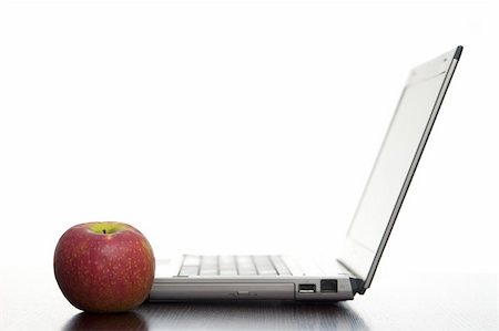 stockarch (artist) - Open laptop sideways on with a fresh red apple in an education concept. Stock Photo - Budget Royalty-Free & Subscription, Code: 400-05919765