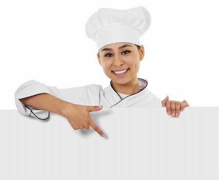 Stock image of female chef holding and pointing at sign with copy space Stock Photo - Budget Royalty-Free & Subscription, Code: 400-05910336