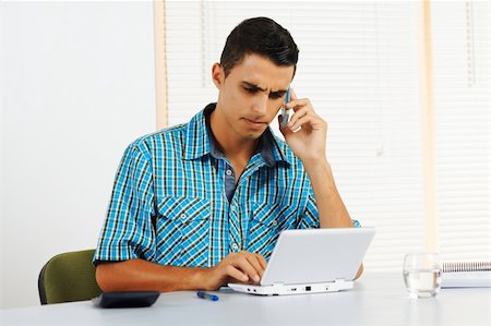 student latino business casual - Young man with frustrated expression using a laptop. Stock Photo - Budget Royalty-Free & Subscription, Code: 400-05910567