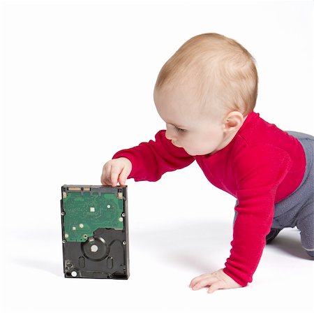 young child in white background with hard drive. red shirt and blue trousers Photographie de stock - Aubaine LD & Abonnement, Code: 400-05910661