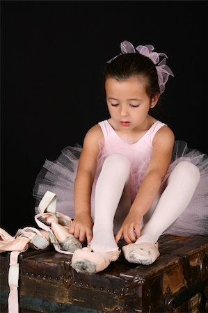 simsearch:400-07302639,k - Cute little brunette girl trying on ballet pointe shoes Stock Photo - Budget Royalty-Free & Subscription, Code: 400-05911840