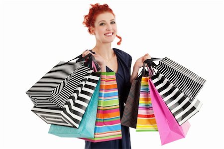 A very happy shopaholic girl holding many shopping bags and smiling about her rabid purchases. Stock Photo - Budget Royalty-Free & Subscription, Code: 400-05912013