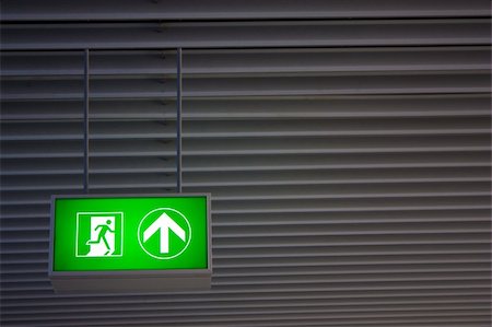 dark people running - Emergency exit sign in modern offices inside an industrial plant Stock Photo - Budget Royalty-Free & Subscription, Code: 400-05912032