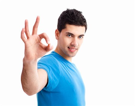 simsearch:400-04343310,k - Portrait of a smiling handsome young man gesturing ok sign over a  white background Photographie de stock - Aubaine LD & Abonnement, Code: 400-05912299