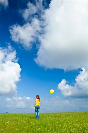 simsearch:400-08262183,k - Happy young woman with a yellow balloon on a green meadow Stock Photo - Budget Royalty-Free & Subscription, Code: 400-05912308