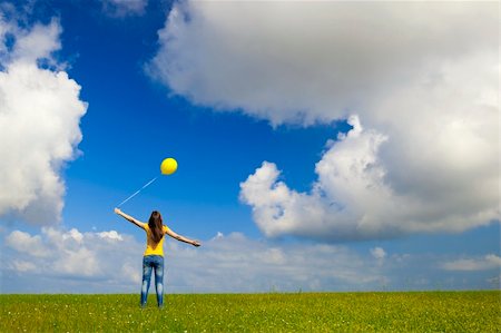 simsearch:400-06077546,k - Happy young woman with a yellow balloon on a green meadow Stockbilder - Microstock & Abonnement, Bildnummer: 400-05912309