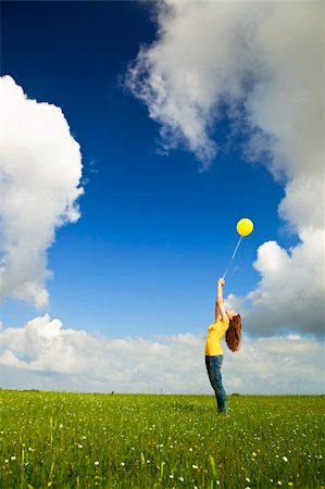 simsearch:400-06077546,k - Happy young woman with a yellow balloon on a green meadow Stockbilder - Microstock & Abonnement, Bildnummer: 400-05912310