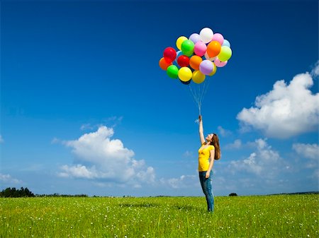 simsearch:400-06077546,k - Happy young woman with colorful balloons on a green meadow Stockbilder - Microstock & Abonnement, Bildnummer: 400-05912311