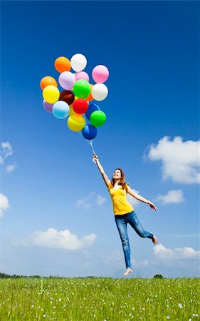 simsearch:400-08262183,k - Happy young woman holding colorful balloons and flying over a green meadow Stock Photo - Budget Royalty-Free & Subscription, Code: 400-05912312