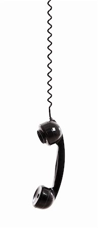 Handset piece from an old phone suspended by the phone cord, isolated on white background Stock Photo - Budget Royalty-Free & Subscription, Code: 400-05912325