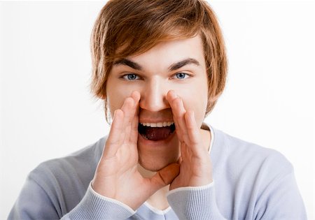 simsearch:400-06065852,k - Portrait of a handsome young man calling someone, isolated over a white background Stock Photo - Budget Royalty-Free & Subscription, Code: 400-05912391