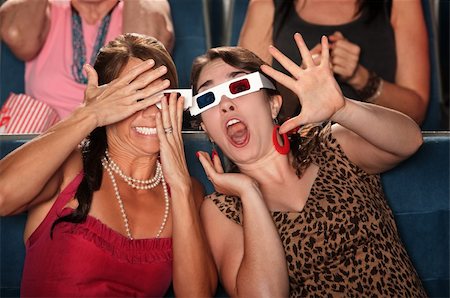 simsearch:400-06138368,k - Two amazed women with 3d glasses react to a movie Fotografie stock - Microstock e Abbonamento, Codice: 400-05913570