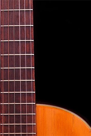 simsearch:400-07301387,k - Detail of classic guitar fretboard (Spanish), against black background. Foto de stock - Super Valor sin royalties y Suscripción, Código: 400-05927358
