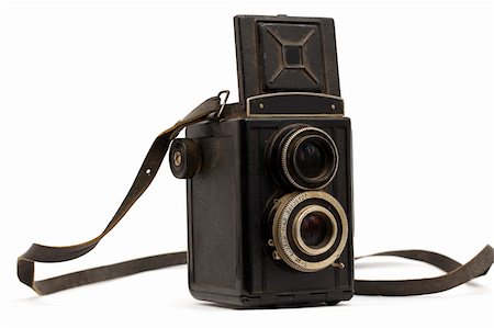 simsearch:693-06667845,k - Old camera with a strap on a white background Photographie de stock - Aubaine LD & Abonnement, Code: 400-05927796