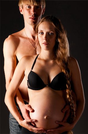 skinny man long hair - Pregnant woman and her man on black background Stock Photo - Budget Royalty-Free & Subscription, Code: 400-05927905