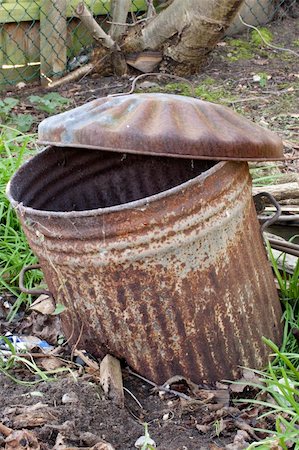 Abandoned rusty old trashcan half buried in the ground Stock Photo - Budget Royalty-Free & Subscription, Code: 400-05920260