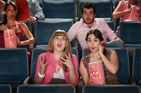 simsearch:400-06138368,k - Group of amazed people watch movie in theater Fotografie stock - Microstock e Abbonamento, Codice: 400-05920987