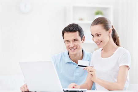 Happy couple with a credit card Stock Photo - Budget Royalty-Free & Subscription, Code: 400-05939233