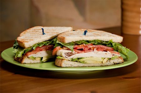 sandwich with avocado - A deli classic turkey sandwich with plenty of turkey, avocado, tomato, and lettuce on white toasted bread. Stock Photo - Budget Royalty-Free & Subscription, Code: 400-05933146