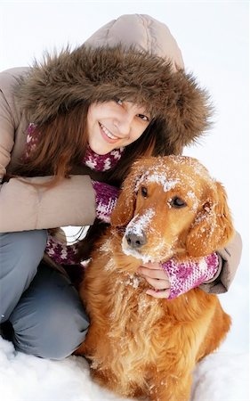 emotional golden retriever - smiling teenager caucasian girl in hood hugging her dog outdoors at snow Stock Photo - Budget Royalty-Free & Subscription, Code: 400-05946443