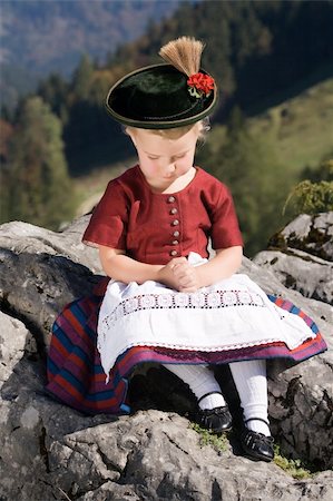 simsearch:400-07087495,k - Little blonde girl in typical Bavarian costume on the mountain and pray Stock Photo - Budget Royalty-Free & Subscription, Code: 400-05946487