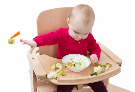 young child in red shirt eating vegetables in wooden chair. Photographie de stock - Aubaine LD & Abonnement, Code: 400-06064010