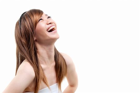 Laughing Asian woman looking up on white background Stock Photo - Budget Royalty-Free & Subscription, Code: 400-06064936