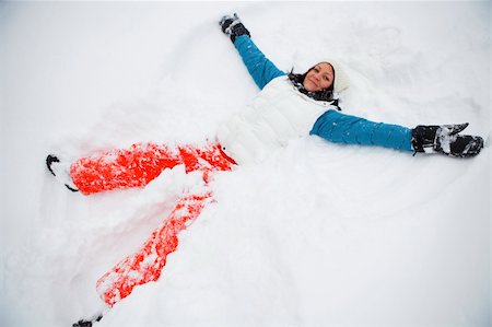 Woman making a snow angel on a white winter day Stock Photo - Budget Royalty-Free & Subscription, Code: 400-06065237